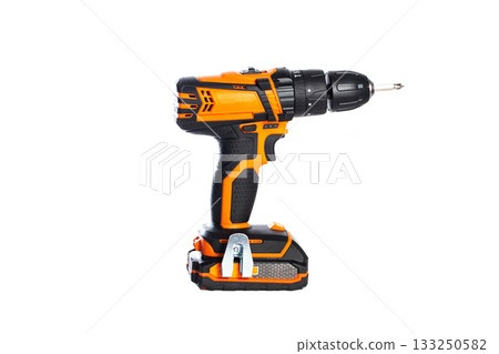 Cordless power drill in bright orange color with a black drill bit for home improvement projects Cordless power drill in bright orange color with a black drill bit for home improvement projects 133250582