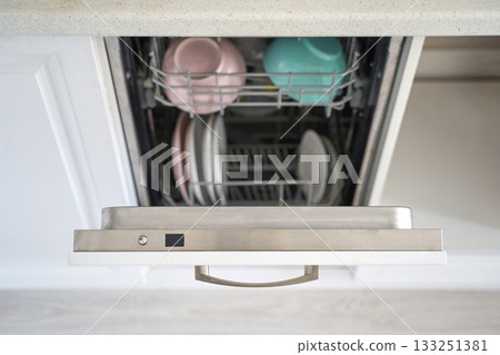 Open dishwasher with clean plates and bowls in kitchen setting Open dishwasher with clean plates and bowls in kitchen setting 133251381