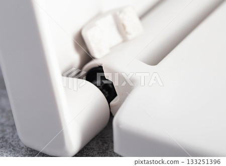 Broken hinge on white toilet seat and lid, close-up, industry, low quality plastic Broken hinge on white toilet seat and lid, close-up, industry, low quality plastic 133251396