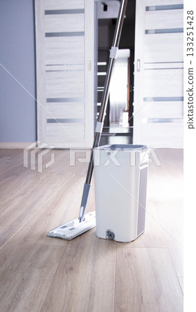 Modern mop with wringer and bucket for easy cleaning, industry. Copy space for text, antistatic 133251428