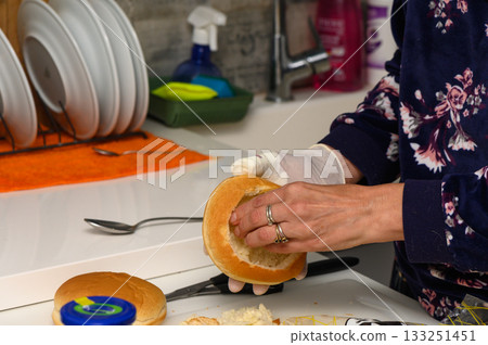Creating a delicious sandwich in a cozy kitchen during a sunny afternoon Creating a delicious sandwich in a cozy kitchen during a sunny afternoon 133251451