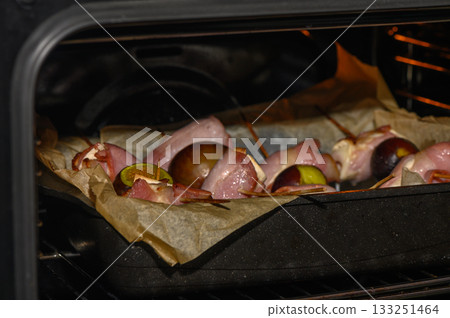 Savory marinated meat skewers with lime roasting in an oven at a cozy home kitchen Savory marinated meat skewers with lime roasting in an oven at a cozy home kitchen 133251464