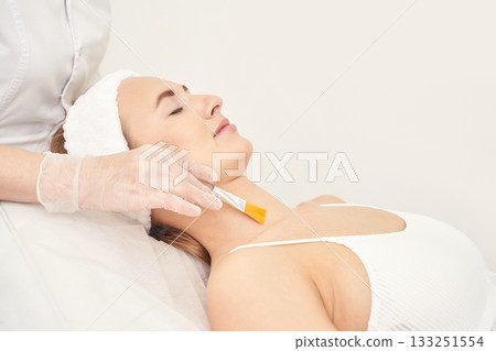 Female caucasian adult receiving facial treatment with brush for skin 133251554