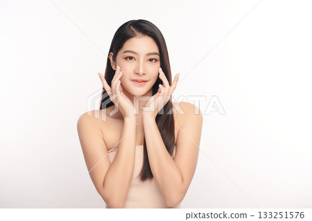 A beautiful young Asian woman with clean, fresh skin against a white background. Skincare, facial treatment, cosmetology, beauty, and spa. An elegant portrait of an Asian woman. 133251576