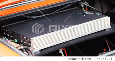 Powerful Car Audio Amplifier Installed In Automobile Trunk. Wires And Connections For Sound System Are Visible. 133251701
