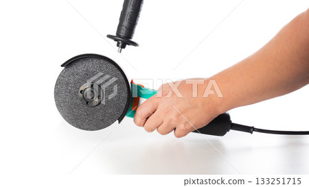 Installing an additional handle in a modern angle grinder on a white background, isolated, close-up Installing an additional handle in a modern angle grinder on a white background, isolated, close-up 133251715