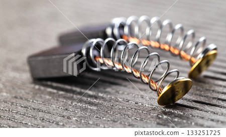 Electric motor brushes on gray background, macro, industry 133251725