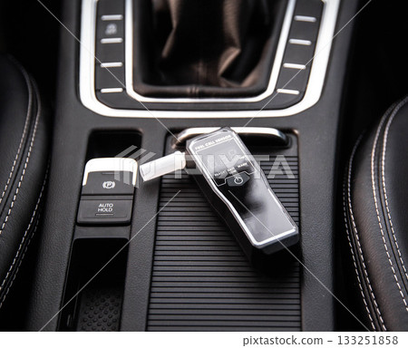 Digital Breathalyzer In Car Center Console. Device For Measuring Blood Alcohol Level. 133251858
