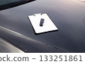Breathalyzer And Clipboard With Blank Paper On Car Hood. Equipment For Documenting Alcohol Test. Driving license revocation for alcohol 133251861