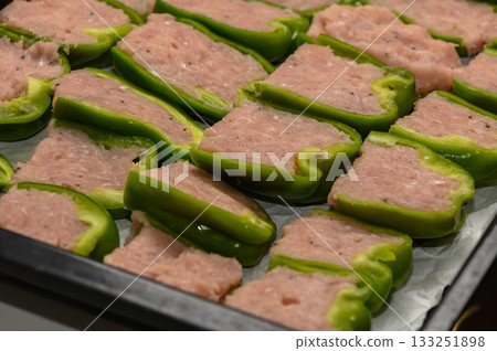 Freshly prepared stuffed green bell peppers ready for cooking in a modern kitchen 133251898