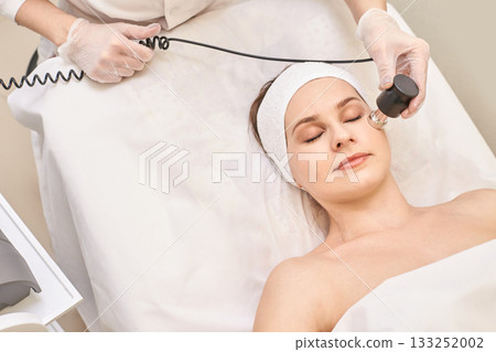 Female caucasian young adult receiving facial treatment in spa 133252002