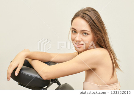 Young caucasian female relaxing on massage chair with calm expression Young caucasian female relaxing on massage chair with calm expression 133252015