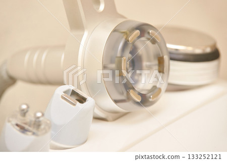 Close-up of modern beauty equipment with led light and metal probes for skin Close-up of modern beauty equipment with led light and metal probes for skin 133252121