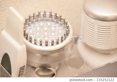 Close-up of hair care tools featuring scalp massager and hairbrush in bathroom 133252122