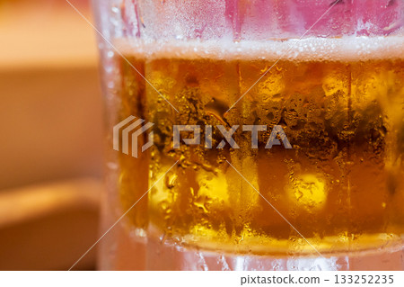 Tiny water droplets condense on a beer glass meant to cool you down in the summer. 133252235