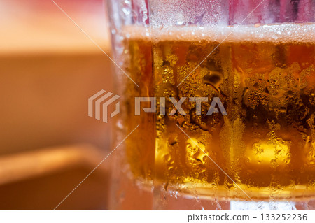 Tiny water droplets condense on a beer glass meant to cool you down in the summer. Tiny water droplets condense on a beer glass meant to cool you down in the summer. 133252236