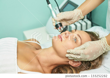 Caucasian female receiving facial treatment in spa relaxation and skincare 133252282
