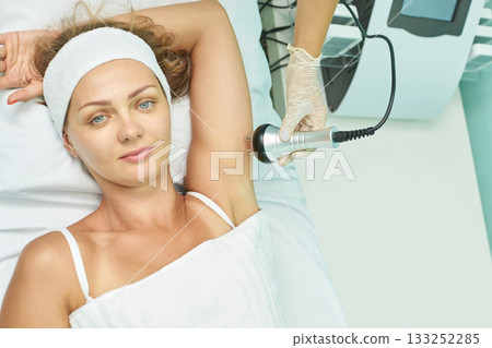 Caucasian female undergoing non-invasive laser hair removal at spa clinic Caucasian female undergoing non-invasive laser hair removal at spa clinic 133252285
