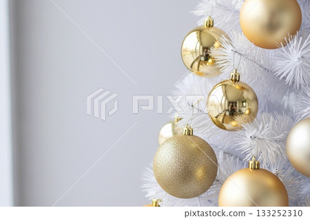 A collection of softly lit interior photos of white Christmas trees and elegant ornaments 133252310