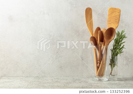 Wooden kitchen utensils and rosemary. 133252396