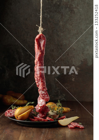 Dry-cured sausages with thyme and pears. 133252418
