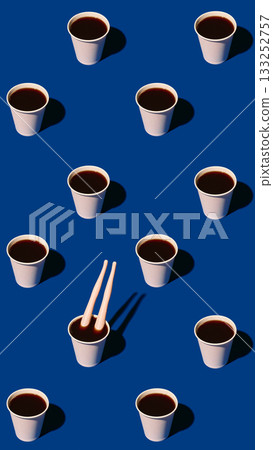 Paper coffee cups and plastic legs in bold pattern on blue background 133252757