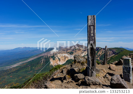 The majestic volcanic terrain and mountain scenery of Mount Tokachi seen from the summit of Mount Furano (Hokkaido) The majestic volcanic terrain and mountain scenery of Mount Tokachi seen from the summit of Mount Furano (Hokkaido) 133253213