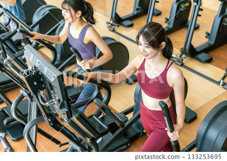 Men and women using cross trainers 133253695