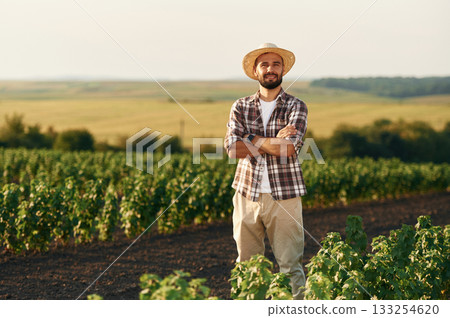 With arms crossed. Farmer is on the agricultural field 133254620