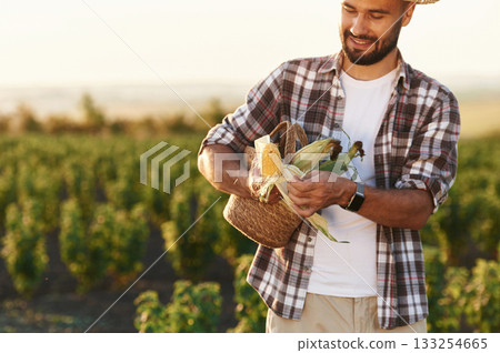 Food in hands, with corn. Farmer is on the agricultural field 133254665