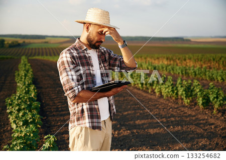 Tired, feeling bad. Farmer is on the agricultural field 133254682