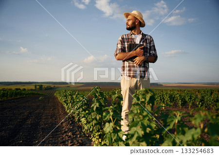 View from the front of him. Farmer is on the agricultural field 133254683