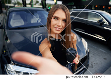 Taking a selfie. Woman is near her car outdoors Taking a selfie. Woman is near her car outdoors 133254990
