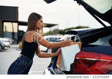 Woman is near her car outdoors 133255084