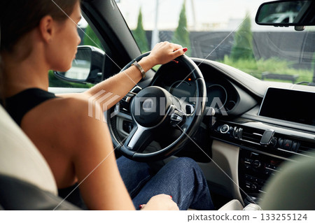 Woman is sitting in the car Woman is sitting in the car 133255124