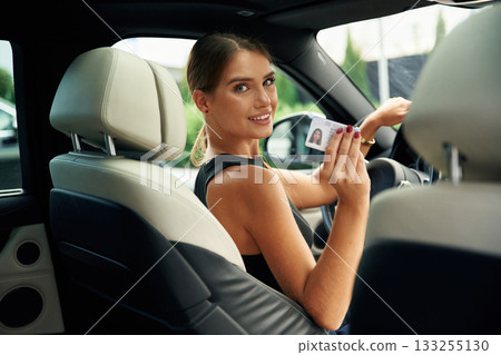 Got driver's license. Woman is sitting in the car Got driver's license. Woman is sitting in the car 133255130