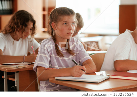 Focused on the lesson. Pupils, kids in the classroom together 133255524