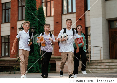Group of kids are near the school together, pupils Group of kids are near the school together, pupils 133255537