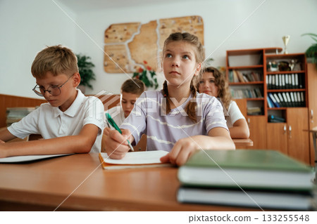 Focused on the lesson. Pupils, kids in the classroom together Focused on the lesson. Pupils, kids in the classroom together 133255548