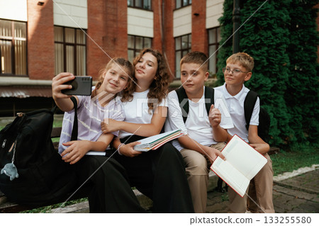 Making a selfie. Kids are near the school together, pupils Making a selfie. Kids are near the school together, pupils 133255580