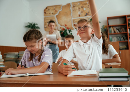 Focused on the lesson. Pupils, kids in the classroom together 133255640