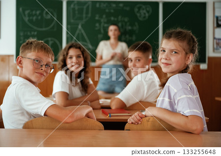 Teacher is at work. Pupils, kids in the classroom together Teacher is at work. Pupils, kids in the classroom together 133255648