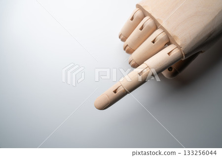 Wooden mannequin pointing pose and white background Wooden mannequin pointing pose and white background 133256044