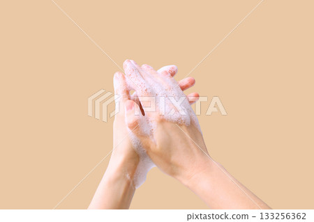 Two hands covered in soap lather rubbing together thoroughly Two hands covered in soap lather rubbing together thoroughly 133256362