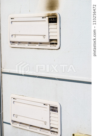 Camper car detail. Grid, ventilation plate for fridge with smoke Camper car detail. Grid, ventilation plate for fridge with smoke 133256472
