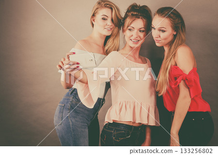 Fashionable women taking selfie Fashionable women taking selfie 133256802