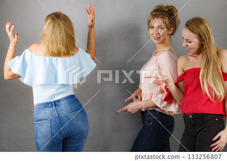 Women gossiping about friend body shape 133256807