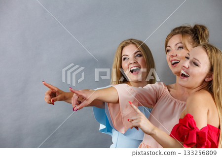 Three fashionable females pointing 133256809