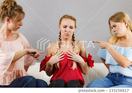 Woman being bullied by two females 133256817