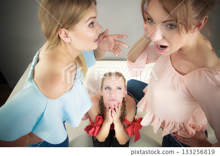 Woman being gossiped by two 133256819